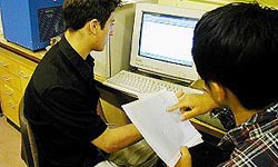 Two students research Mars on-line.