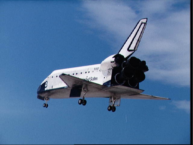 Photo of the Shuttle returning from orbit, with the landing gear deployed.