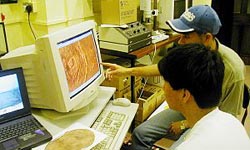 Two students research Mars on-line.